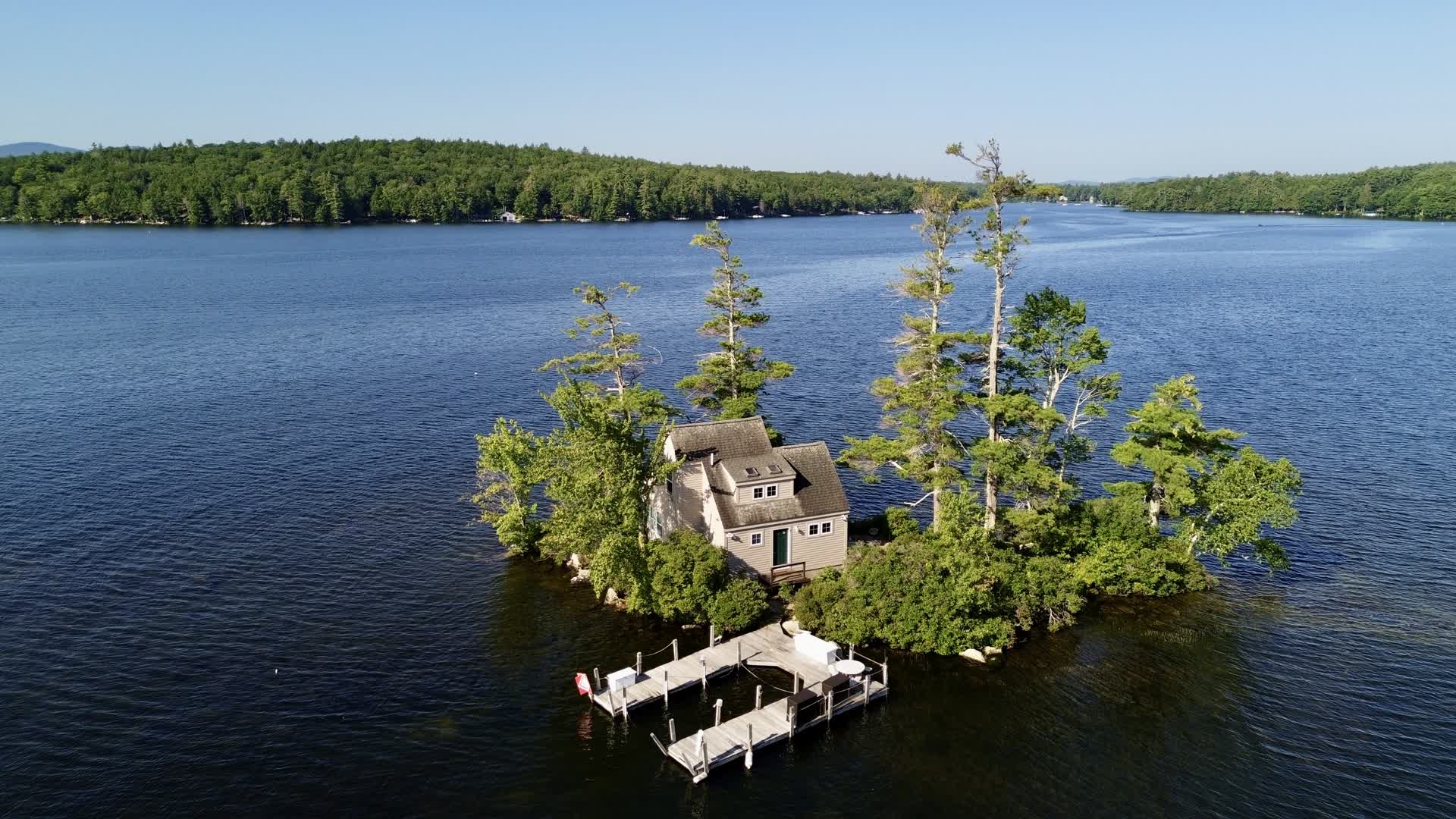 Aerial drone view of a private island home on Lake Winnipesaukee